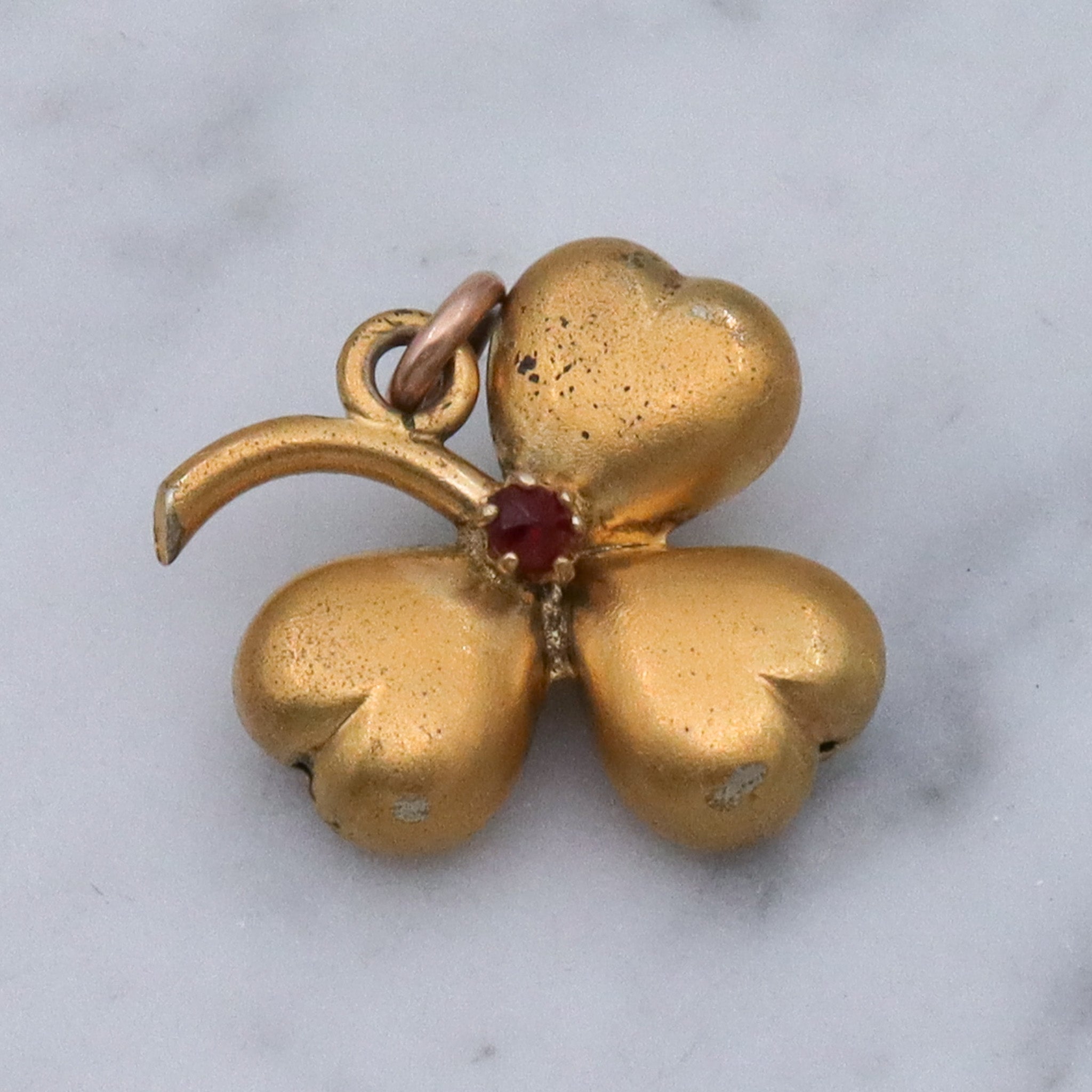 Antique Victorian gilt metal clover with faux garnet pendant
